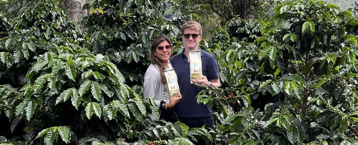 Brown & Blanco amongst a many coffee plants.